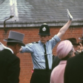 Police man in bola hat directing crowds at the Royal Ascot