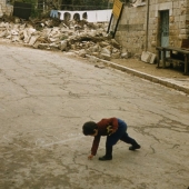 Boy with chalk on street near border, 1958